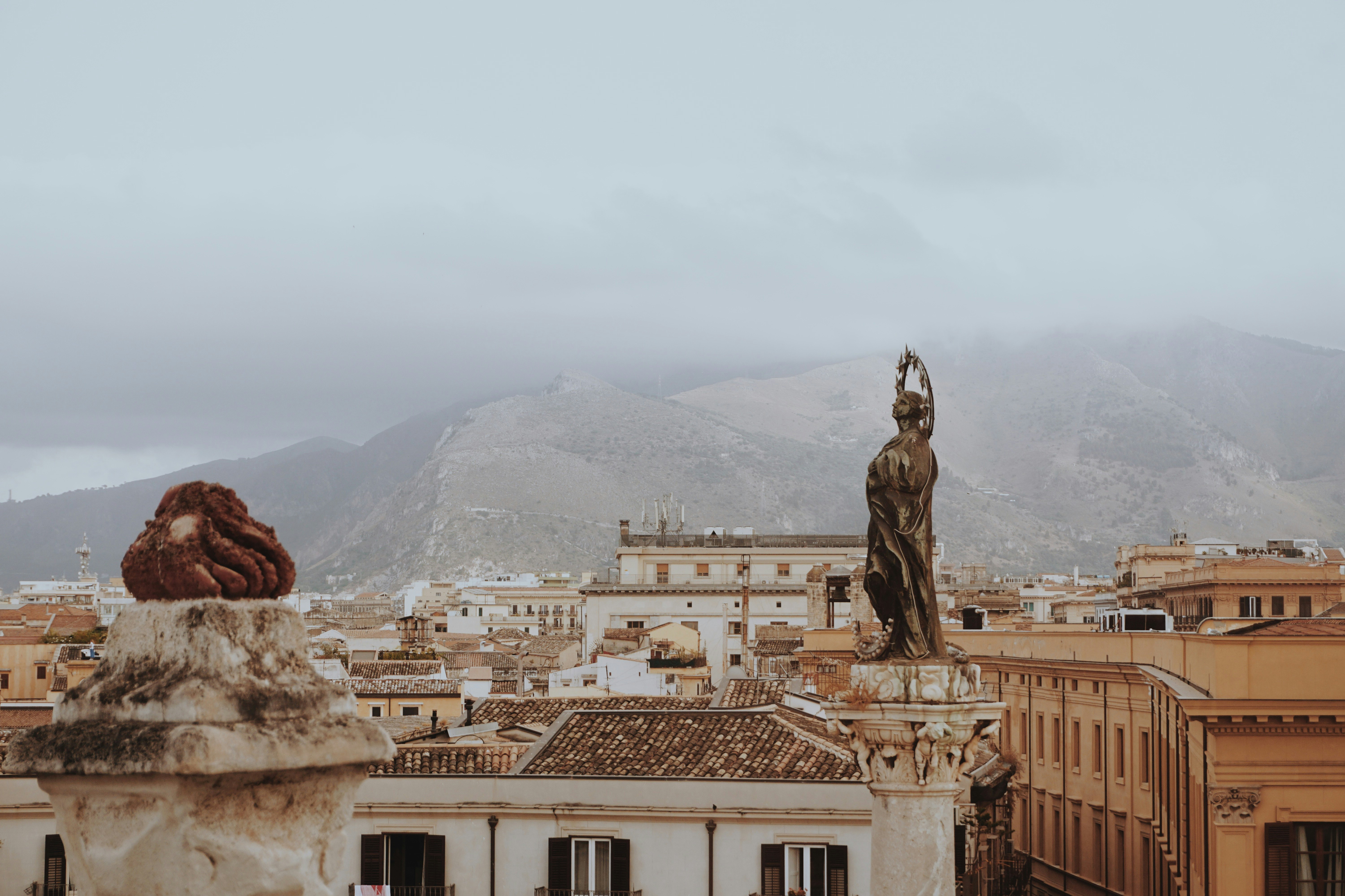 man statue on top of building